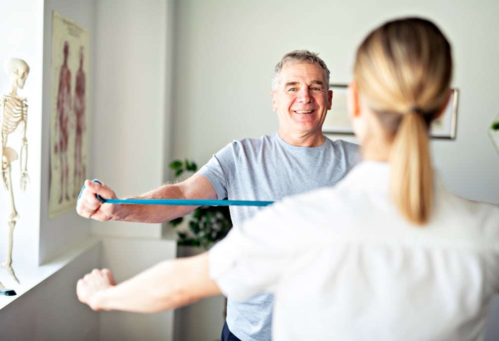 physiotherapist with client